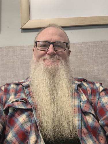 Reviewer's selfie wearing a plaid shirt while using Primal Testosterone Booster.