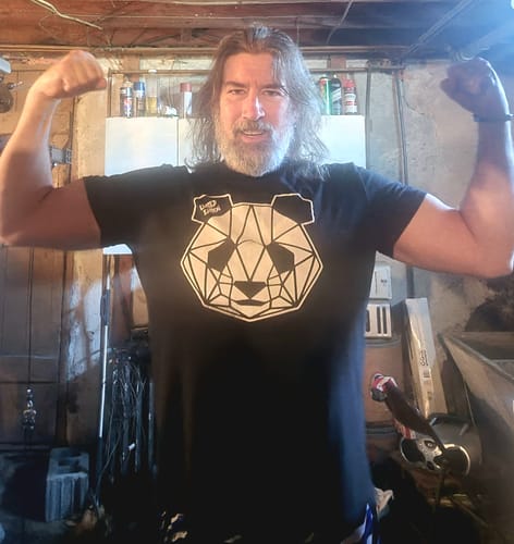 Reviewer flexing both biceps to demonstrate their strength and energy.