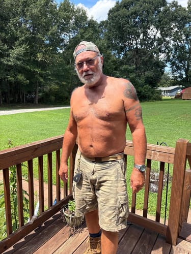 Reviewer stands shirtless on a deck, providing a photo of his physique for the product review.