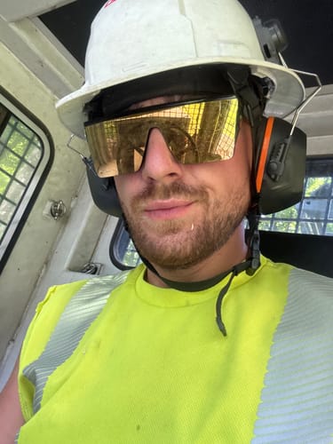 Customer's Triple Testosterone Booster Ritual user wearing protective construction gear, including a hard hat and earmuffs.